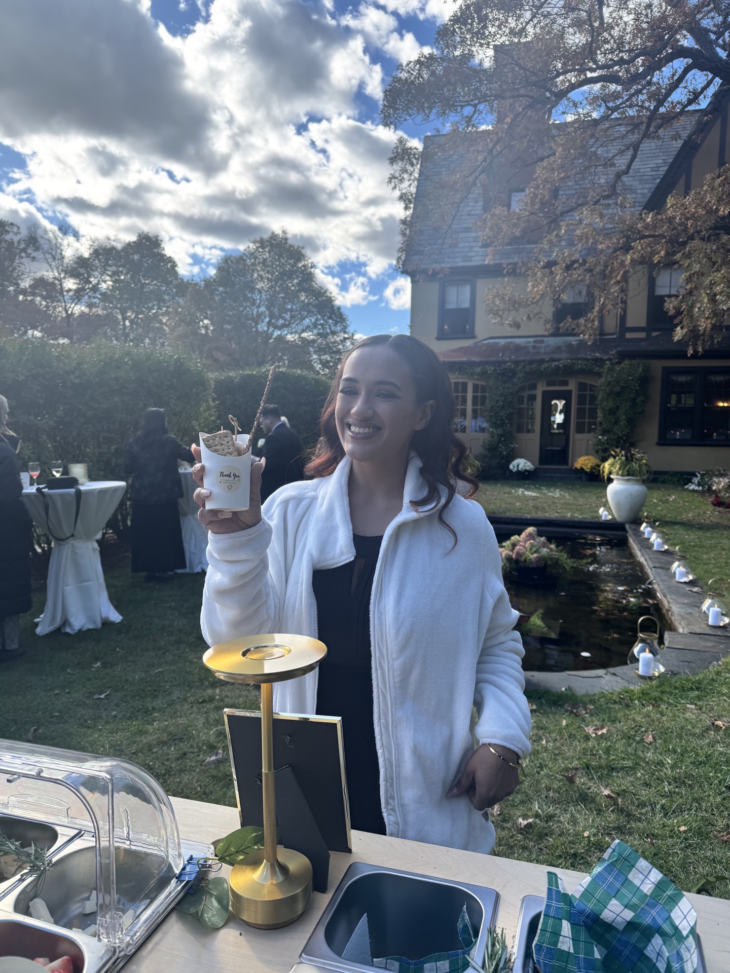 Guest enjoying grazing cup at outdoor event